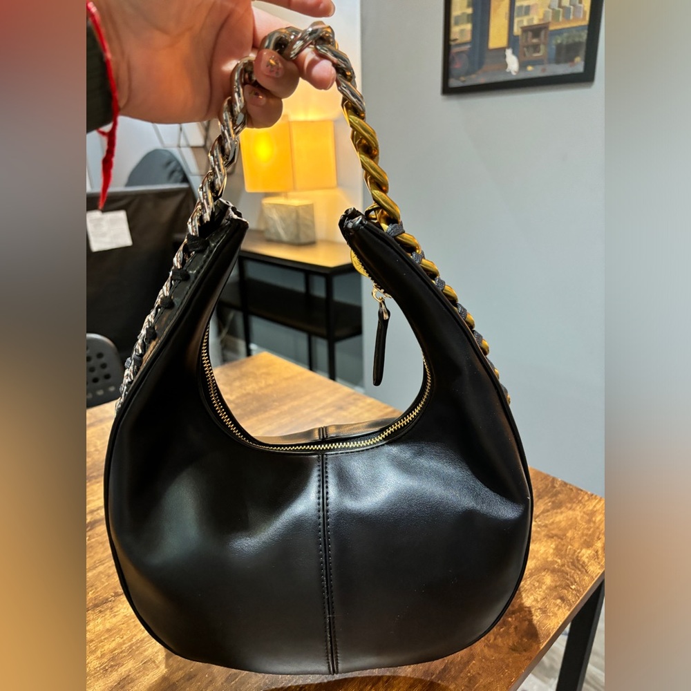 Black leather bag with gold and silver chain detail